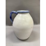 A large stoneware jug of ovoid form, glazed in blue to the neck and handle, printed mark to