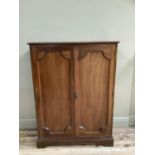 A mahogany two door indented panel cupboard on bracket feet, 92cm by 124cm high