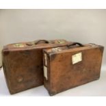 Two vintage leather suitcases, one with brass locks, 70cm and 63cm wide