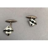 A pair of Art Deco silver black and white champleve enamel set cufflinks