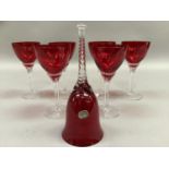A set of six ruby glass and clear stemmed wines and a ruby glass table bell