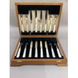 A walnut canteen of eight mother-of-pearl handled EPNS fruit knives and forks