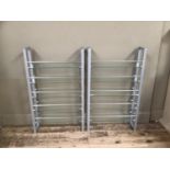 A pair of grey metal chrome and tempered glass open shelves for DVD's, 60cm wide x 100cm high.