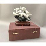 A mineral carving of opposing dragons chasing the flaming pearl stood upon the back of a tortoise