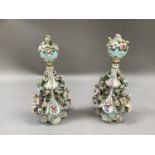 A pair of late 19th/early 20th century Dresden porcelain floral encrusted bottle vases and