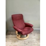 A Stressless reclining swivel armchair on beech base, upholstered in rust velour.