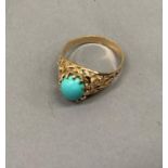 A turquoise ring, the oval cabochon stone claw set flanked by pierced shoulders in yellow metal