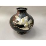 A large Japanese bronze effect vase inlaid in white metal with cranes in flight, of compressed
