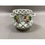 A modern Dresden plant holder of pierced basket form, twin handles and encrusted with flowers,