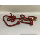 A red braided banister rope with knopped finials and four brass wall brackets, approx 435cm long
