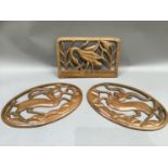 Three African panels carved and pierced, two with antelope and one with bird carrying a fish, 43cm