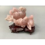 A Chinese rose quartz carving of a peach shaped cup and cover with songbirds and blossom, 11cm