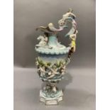 A continental porcelain ewer polychrome painted and glazed, moulded with a continual band of cherubs