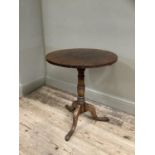 A 19th century oak tripod table, circular top and turned column on pad feet