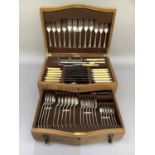 An oak canteen of EPNS cutlery for six including table forks, dessert forks, table knives and