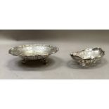 A George V silver bonbon dish, circular with bracketed rim and pierced border on three stepped feet,