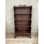 Mahogany finish 5 tier waterfall bookcase with 2 drawers below and on shaped bracket feet.