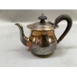 A silver George V bachelor's teapot with composition handle, Birmingham date letter worn,