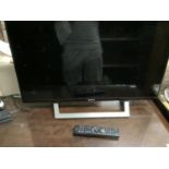 A Sony Bravia flatscreen television with remote control, approximately 82cm screen (32 inch)