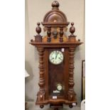 A Victorian walnut wall clock by Gustav Becker having a two part dial, the case with arched