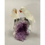 A Brazilian specimen mineral pair of parakeets perched on a rock, 11.5cm high