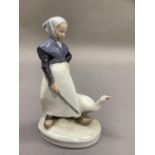 A Royal Copenhagen figure of a goose girl and gander, printed and painted mark 528