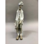 A large Lladro figure of a clown sitting upon a pedestal with an accordion in his hand, 35cm high