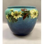 A late Victorian art pottery jardiniere, moulded and painted with blossom in pale yellow, green