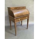 A mahogany quarter veneered cylinder bureau having two drawers above the cylinder, the interior