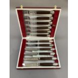 A silver plated hard wood handled steak knives and forks with Sheffield stainless steel blades, in