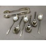 A set of six apostle spoons, Sheffield 1921, together with a pair of sugar tongs cast with shells,