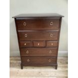 Stag Minstrel 5 height chest of drawers together with a double bedhead.