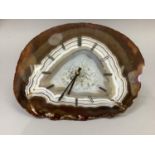 An agate faced clock in shades of brown and ivory with gilt metal baton numerals and hands, with