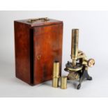 A Victorian brass microscope by H Hughes & Son, 59 Fenchurch St, London, with additional lenses in a