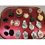 A collection of Chinese snuff bottles in ceramic, resin and hardstone, together with netsukes in