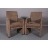 A pair of taupe suede-effect armchairs, on castors (marks to arms)