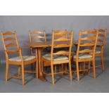 An Ercol pale elm dining table and six chairs, design no. 823 rounded rectangular table on refectory