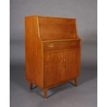 A teak secretaire c. late 1960s, the drop front fitted with drawers and pigeon holes, above a drawer