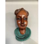 Achatit, Germany, a ceramic wall mask of a female with braided coiffure, impressed mark and