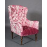 A John Sankey winged armchair, deep button upholstered in shocking pink toile and velvet on turned
