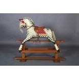 An Edwardian style rocking horse, cream and black dapple finish, horsehair mane and tail, leather