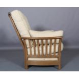 An Ercol Light Golden Dawn armchair with slatted back and arms with fawn fabric cushions to the