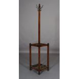 An oak hall stand c.1930s, with four hat and coat pegs, the square section base with drip trays for,