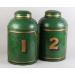 A pair of 19th century toleware tea canisters, cylindrical, the green ground with panel and