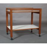 A walnut and white melamine two tier trolley c.1970s with galleried sides and ebonised rail ends, on