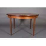 A G Plan teak extending dining table, of circular outline, with extra pop-up leaf, on rounded and