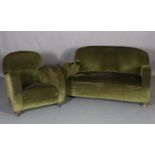 An Art Deco two seater sofa and armchair with curved arms, upholstered in green velvet, on bun