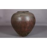 A large glazed earthenware vessel, of tapered compressed globular form with three lugs to the