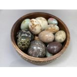 A collection of polished stone eggs and balls comprising three balls approximately 8cm diameter, and