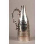 AN EARLY 20TH CENTURY SILVER PLATED WINE BOTTLE HOLDER, of bottle shape, engraved vacant